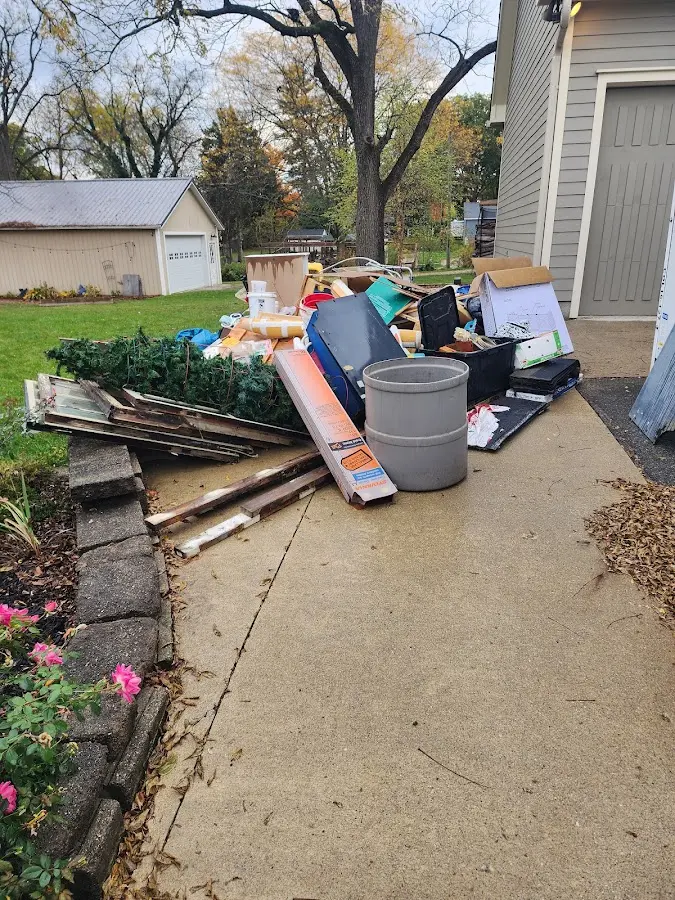 Dumpster being loaded with debris for 12 Yard Dumpster Rental in Centerville